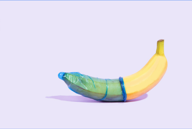 Blue condom on a banana highlighting the need for better sex education.